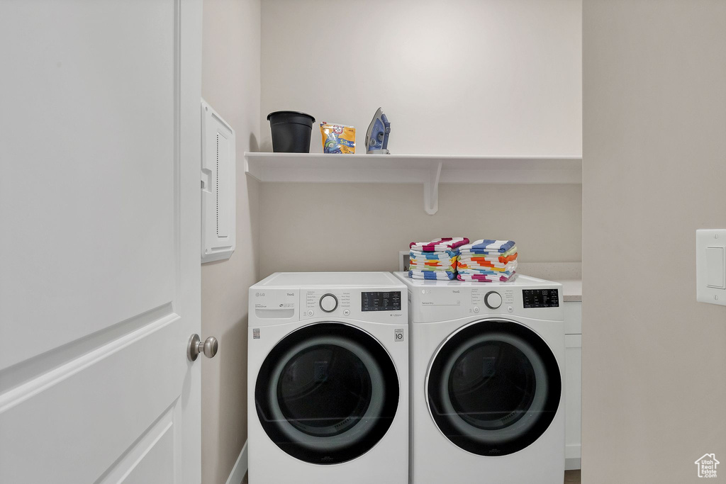 Washroom featuring washing machine and clothes dryer