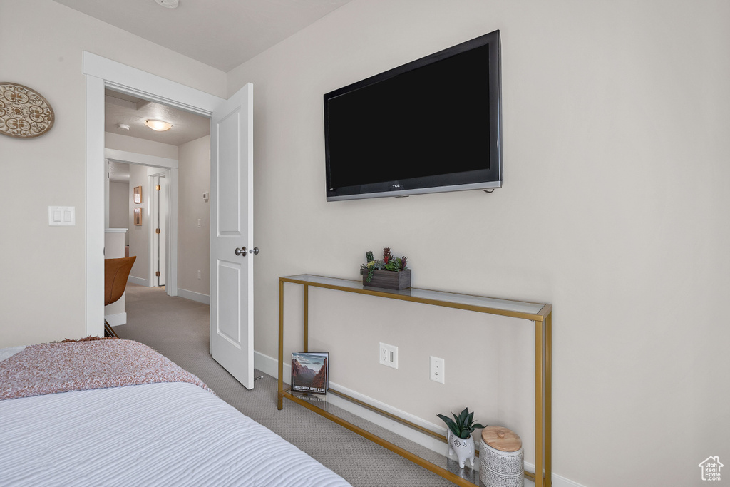 Carpeted bedroom featuring baseboards
