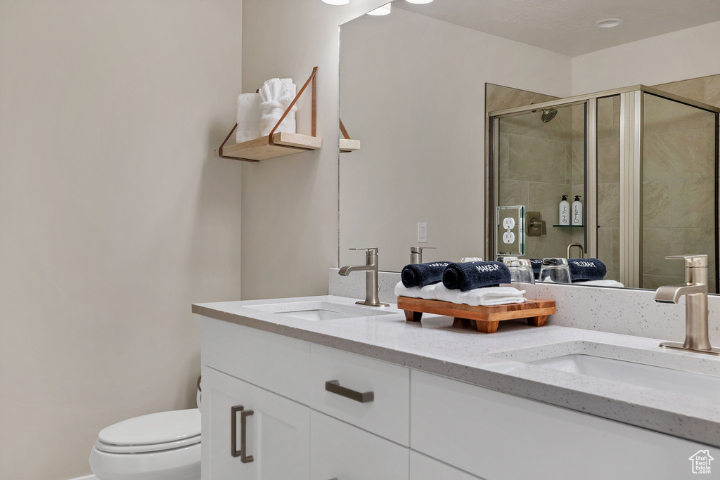 Full bath with double vanity and a stall shower