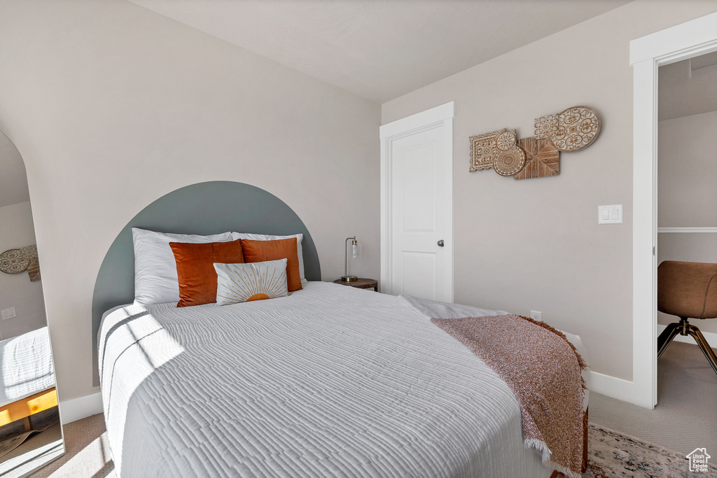 Bedroom with carpet flooring and baseboards