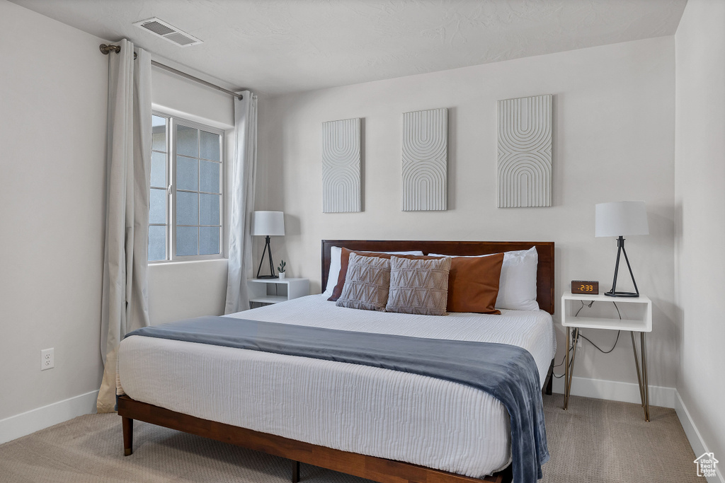 Carpeted bedroom with baseboards
