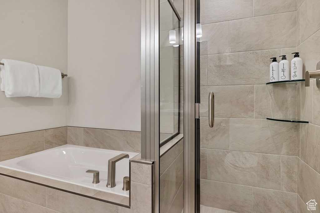 Full bathroom with a garden tub and a shower stall