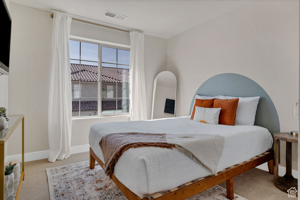 Bedroom featuring carpet and baseboards