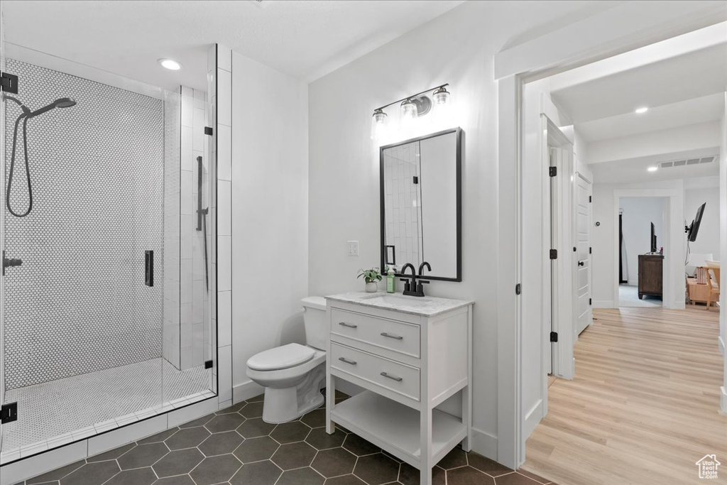 Full bathroom with a stall shower, vanity, recessed lighting, and tile patterned floors