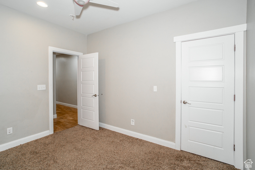 Unfurnished bedroom featuring carpet flooring and ceiling fan