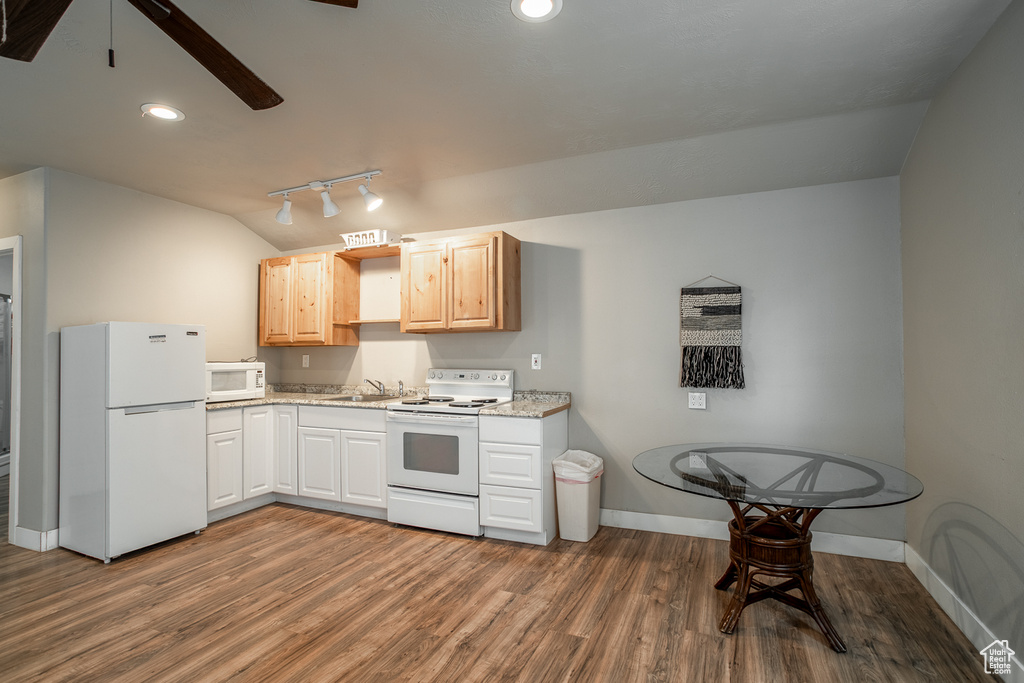Kitchen with white appliances, dark wood-type flooring, ceiling fan, lofted ceiling, and recessed lighting