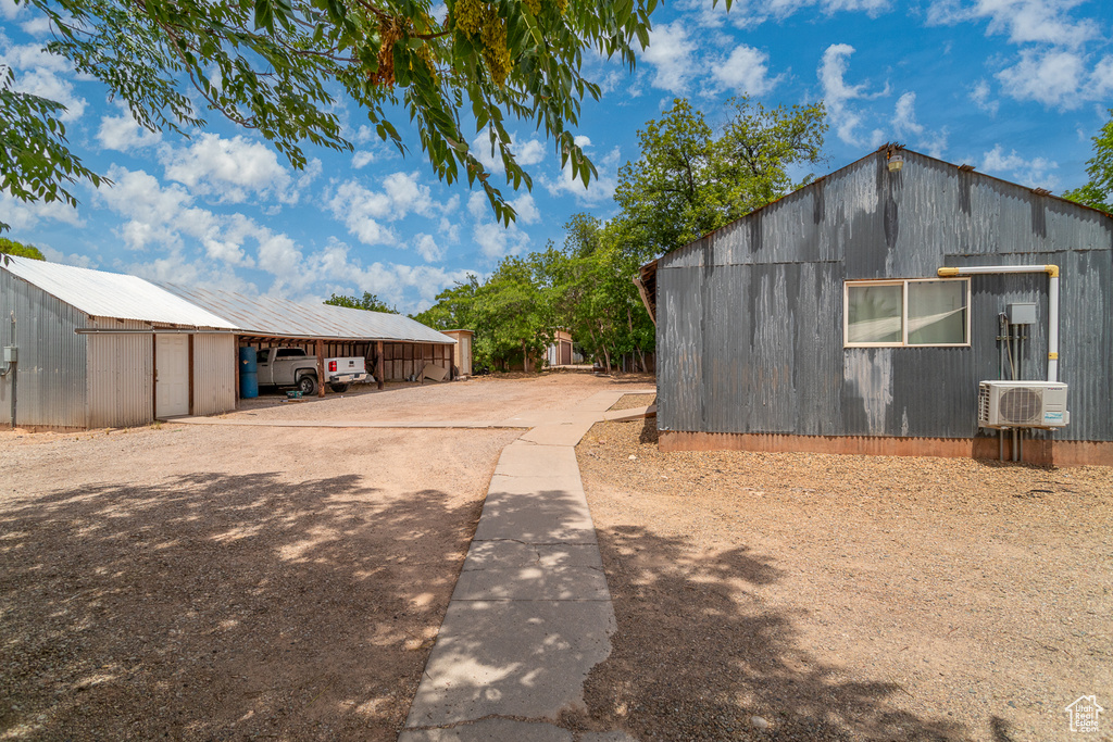 View of home\'s exterior featuring an outbuilding, an outdoor structure, and concrete driveway