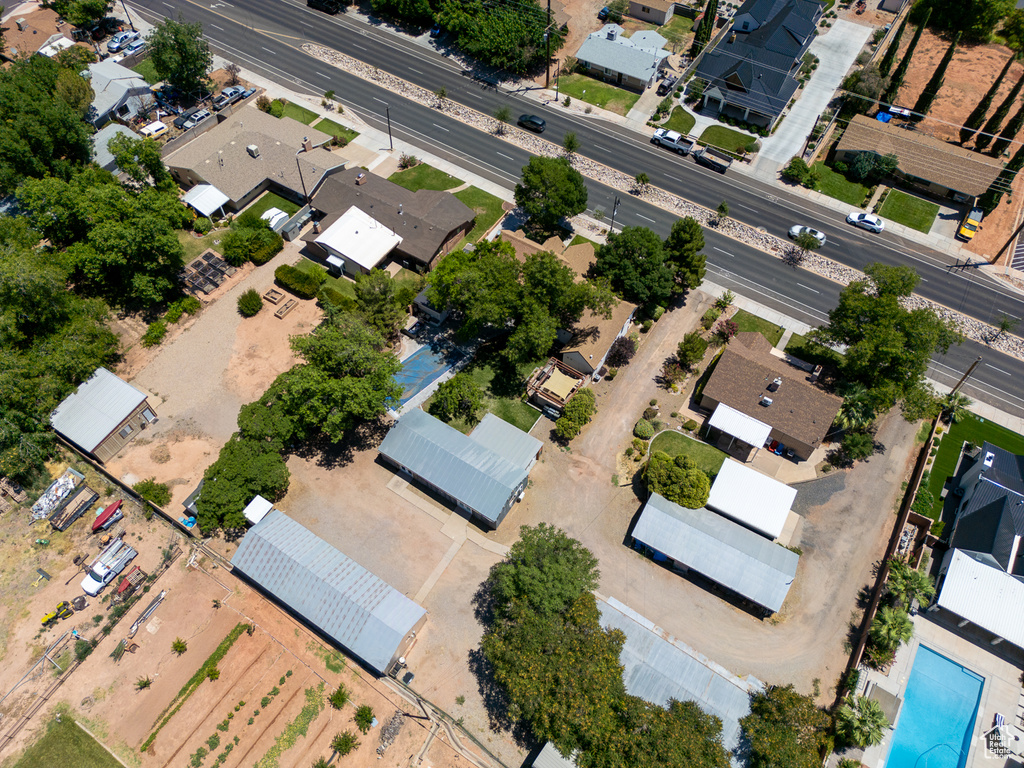 Aerial view of property and surrounding area featuring nearby suburban area
