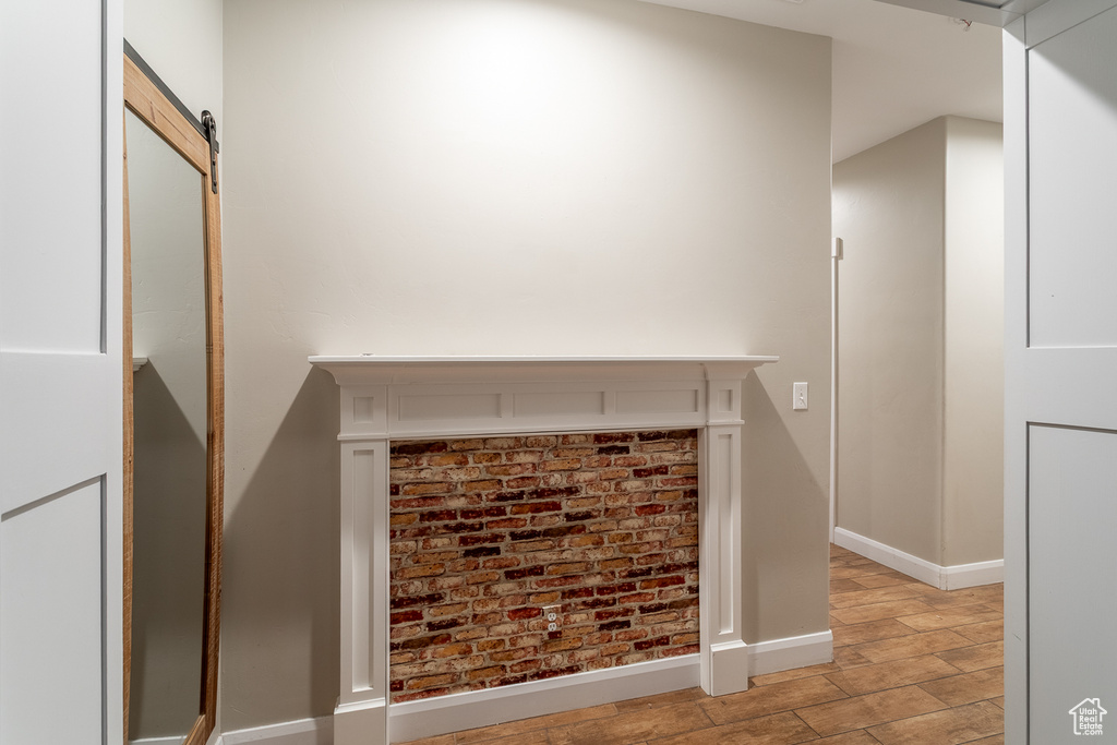 Detailed view of wood finished floors and a barn door
