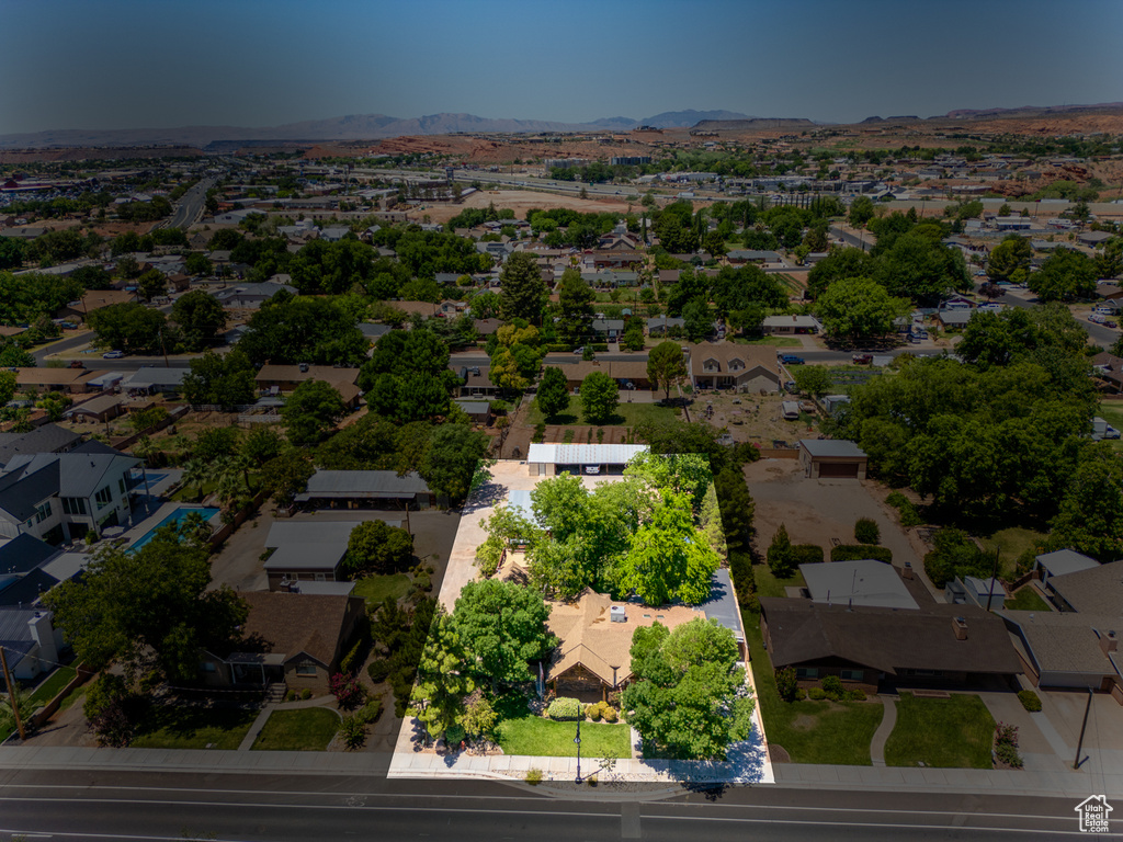 Aerial perspective of suburban area with a mountainous background and property parcel outlined