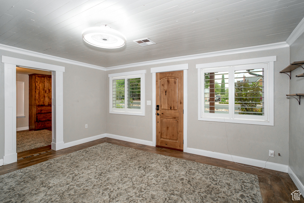 Foyer featuring wood finished floors and ornamental molding