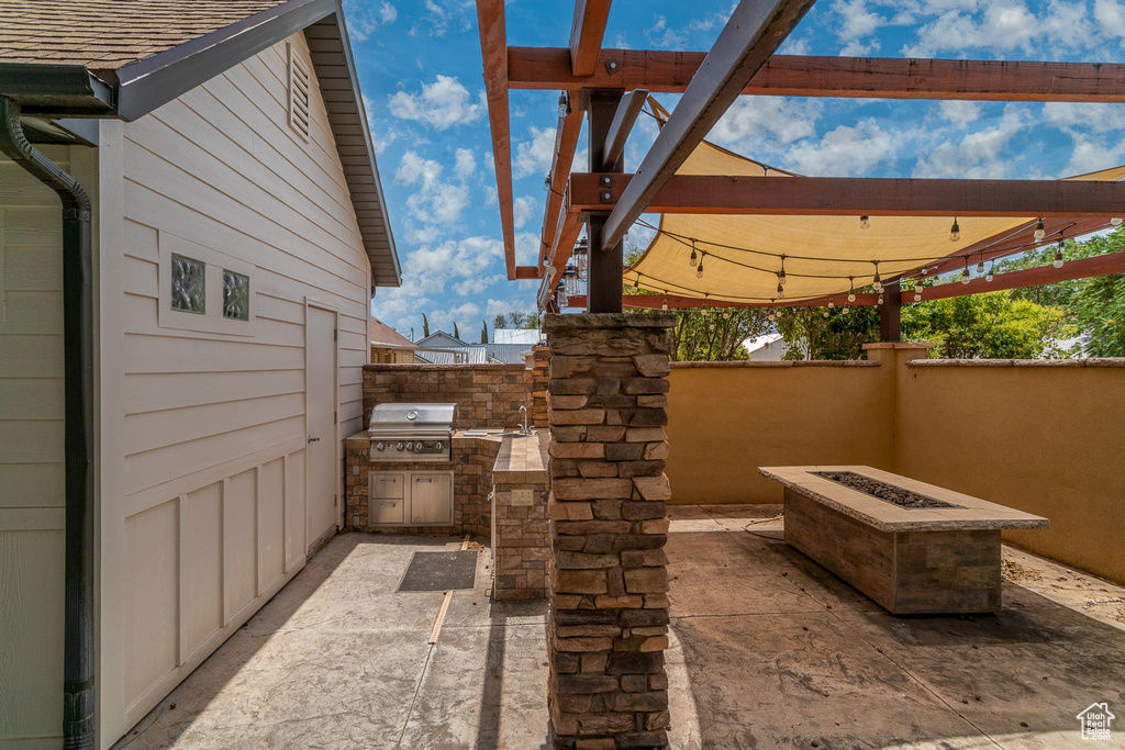 View of patio / terrace with a fire pit and area for grilling