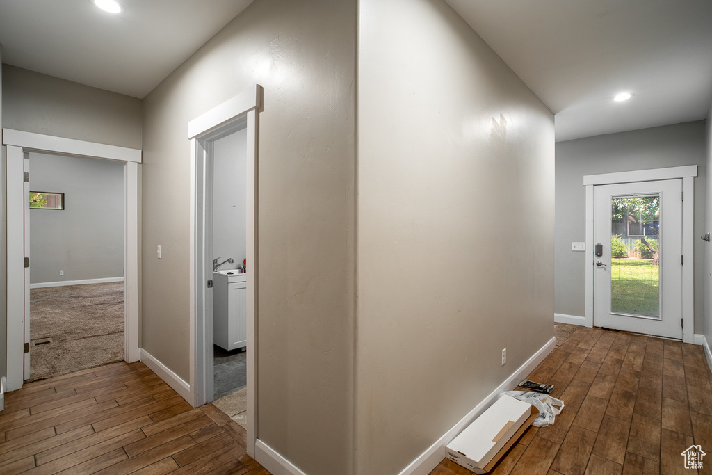 Corridor with wood finished floors and recessed lighting