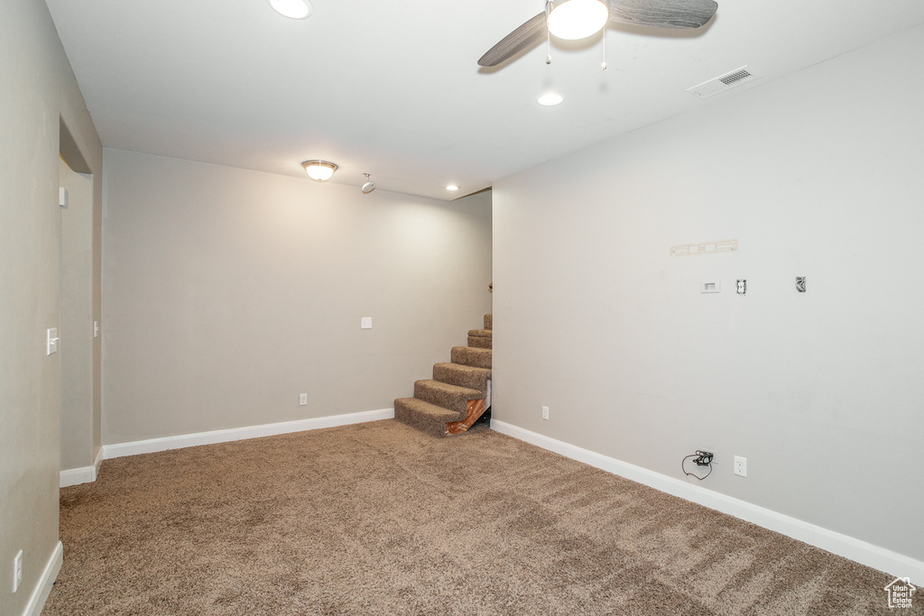 Basement featuring carpet floors, recessed lighting, stairway, and ceiling fan