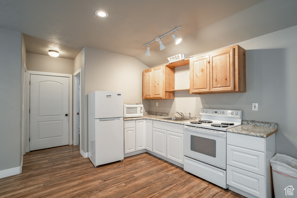 Kitchen with white appliances, track lighting, dark wood finished floors, open shelves, and vaulted ceiling