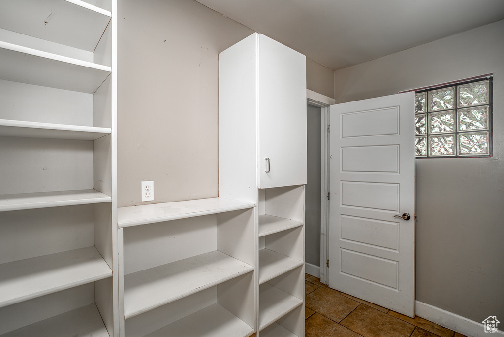Walk in closet featuring tile patterned flooring