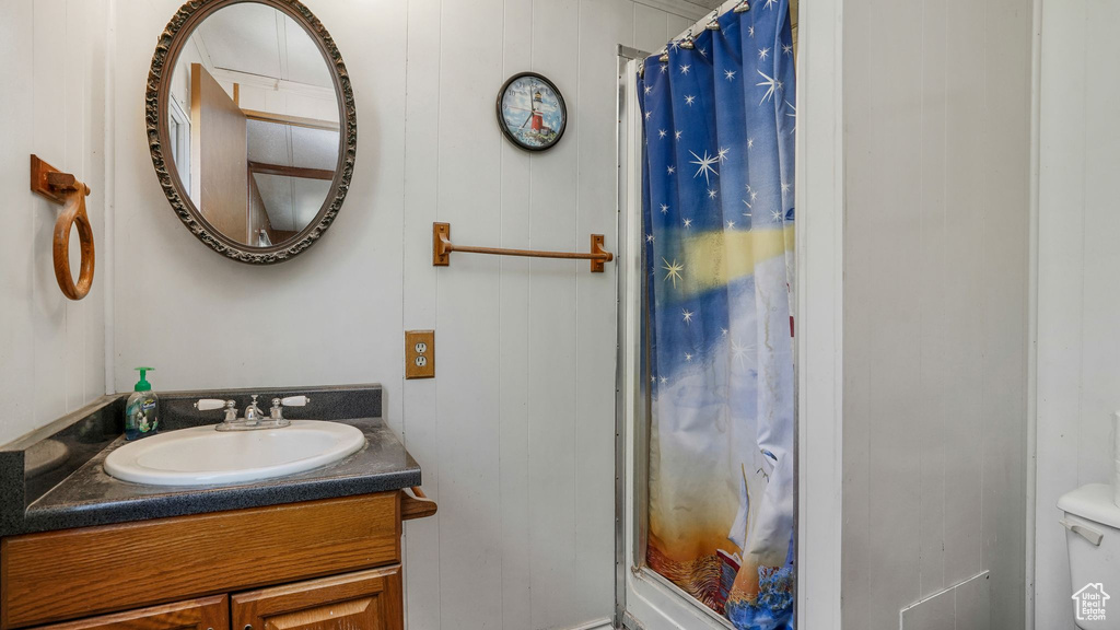 Full bath featuring vanity and a shower with curtain