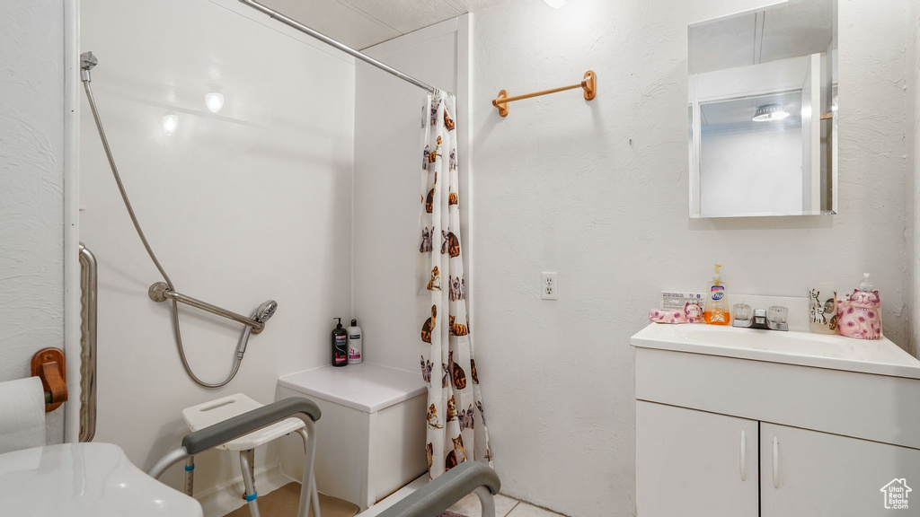 Full bathroom with vanity and a shower with shower curtain