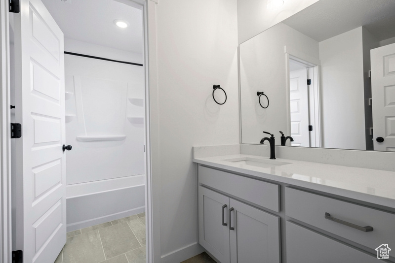 Full bath featuring vanity, shower / washtub combination, and recessed lighting