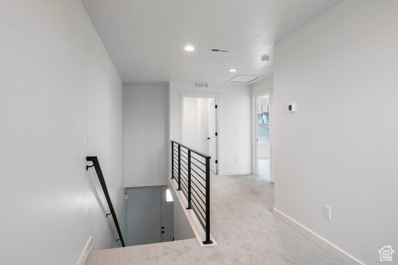 Staircase featuring carpet and recessed lighting