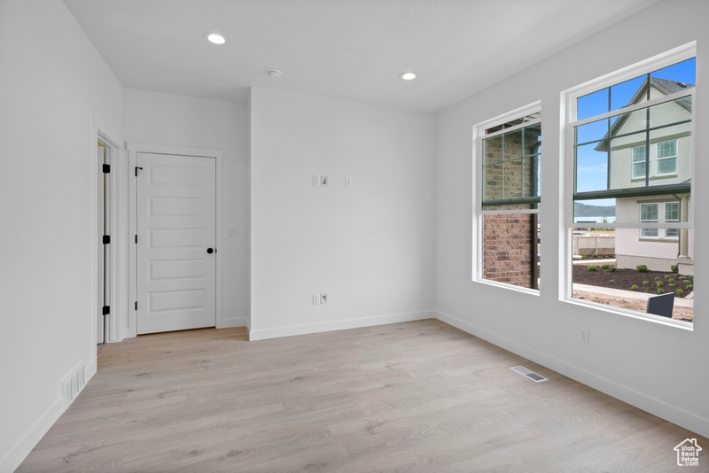 Spare room featuring wood finished floors and recessed lighting