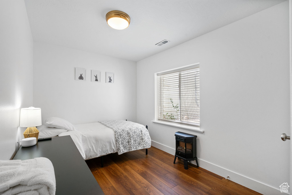 Bedroom featuring baseboards and wood finished floors