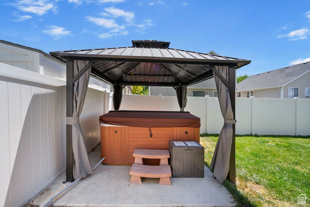 View of patio / terrace featuring a gazebo and a hot tub