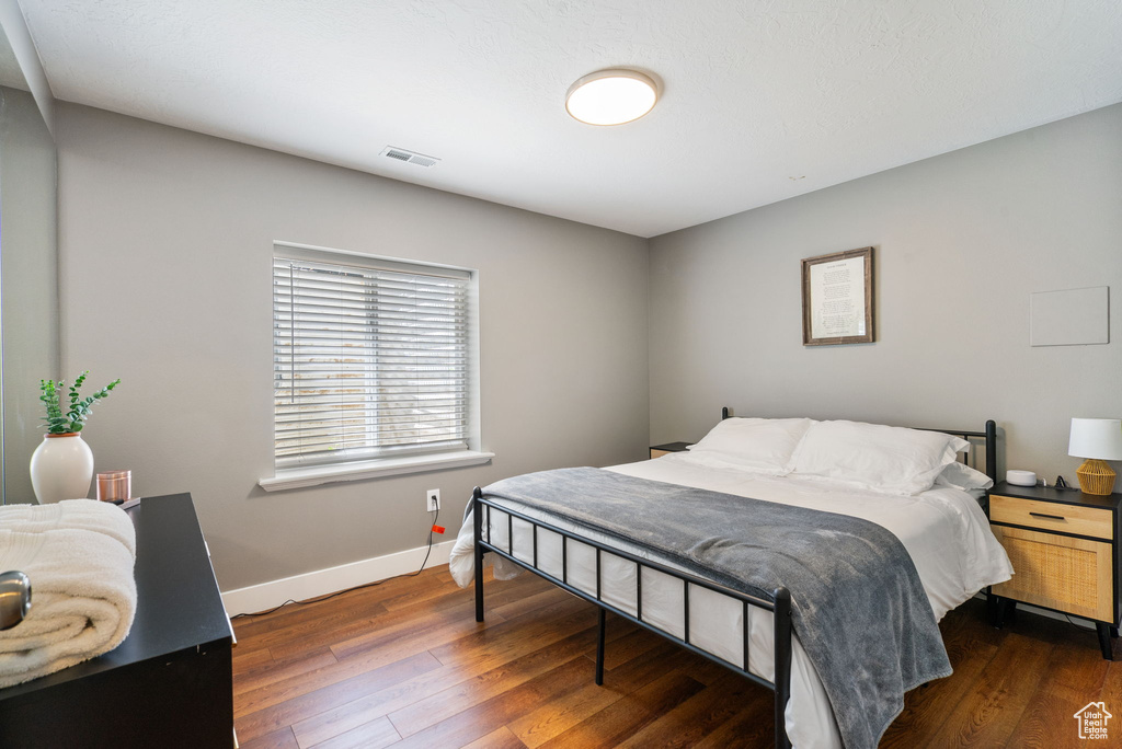 Bedroom with hardwood / wood-style floors