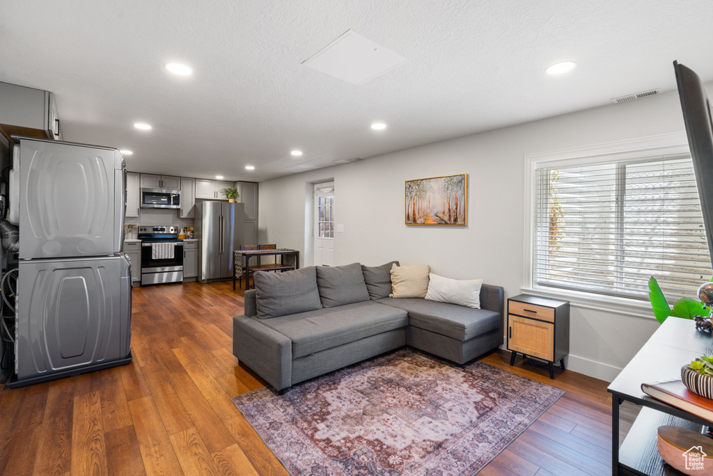 Living room with recessed lighting and dark wood-style floors