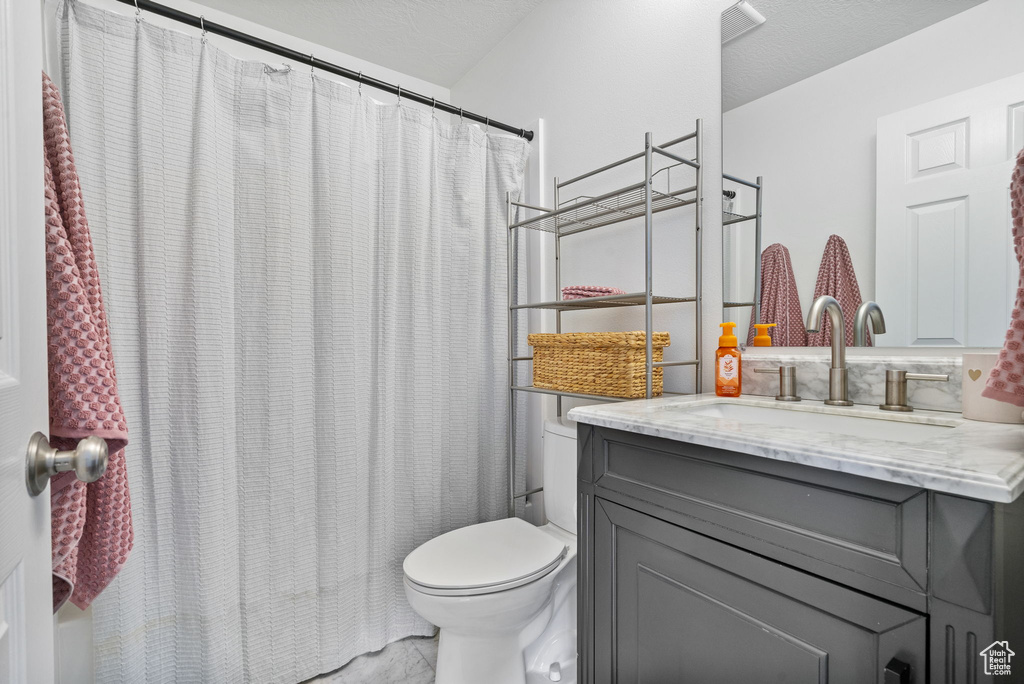 Full bath with vanity and a shower with curtain
