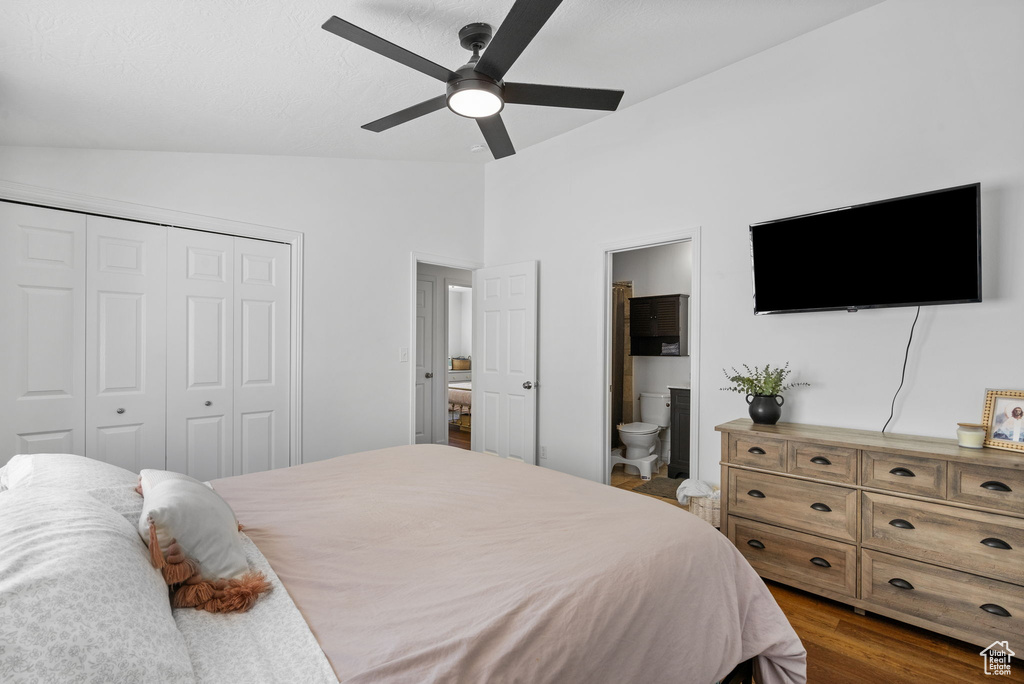 Bedroom featuring lofted ceiling, a closet, dark wood finished floors, ensuite bathroom, and ceiling fan
