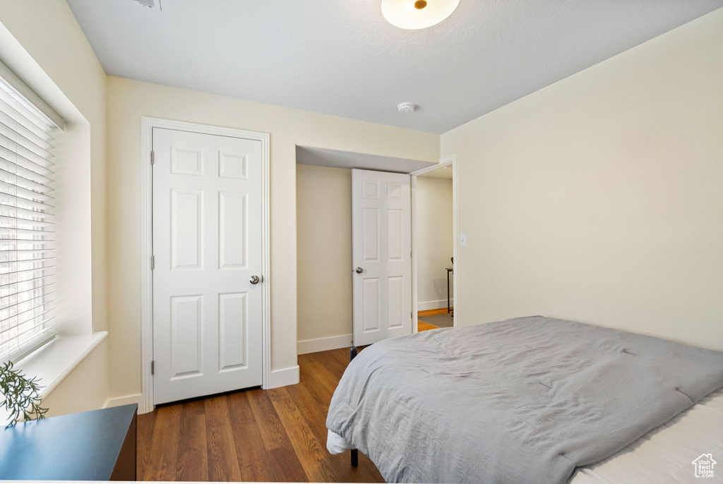Bedroom featuring wood finished floors and baseboards