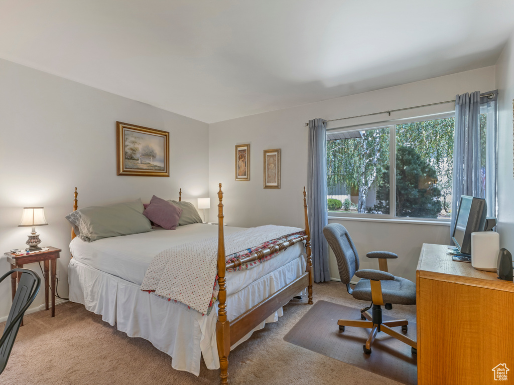 Bedroom featuring carpet and a desk