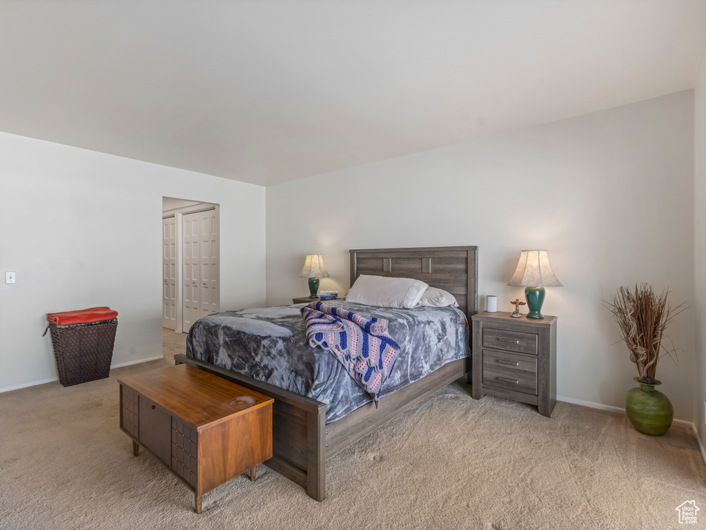 Bedroom featuring light carpet and baseboards
