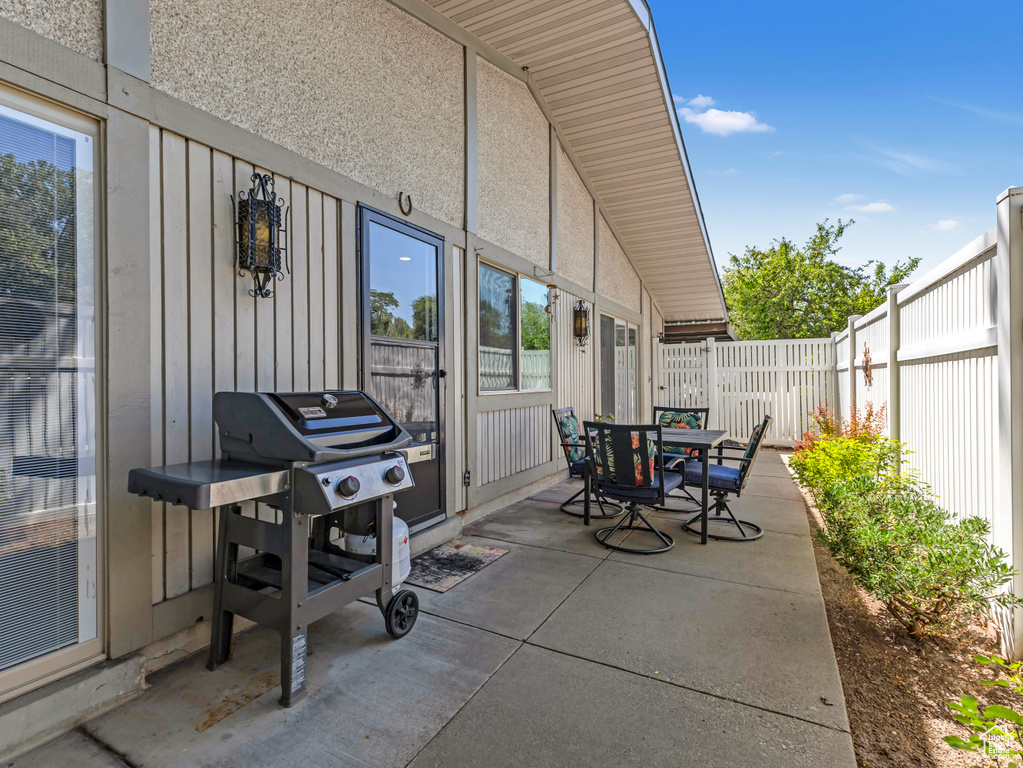 Fenced backyard with a patio, outdoor dining area, and area for grilling