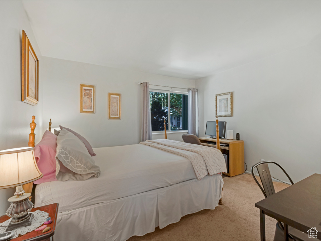 Bedroom featuring light colored carpet