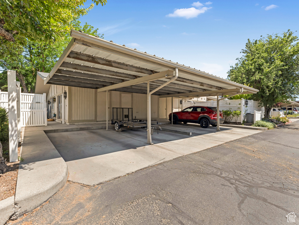Covered parking lot featuring a gate