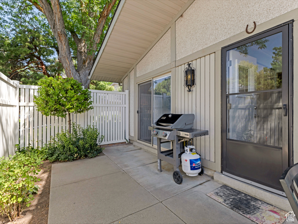 View of patio with a grill