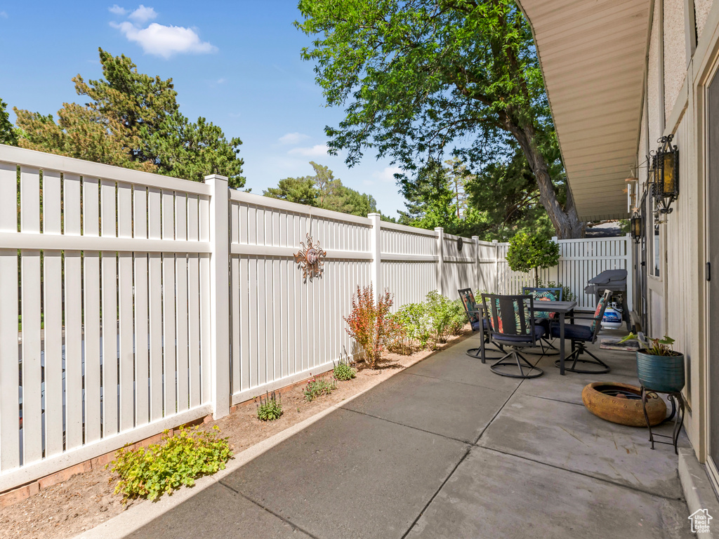 Fenced backyard with outdoor dining area and a patio