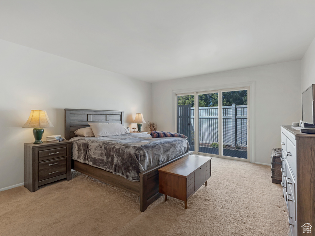 Bedroom with access to outside and light colored carpet