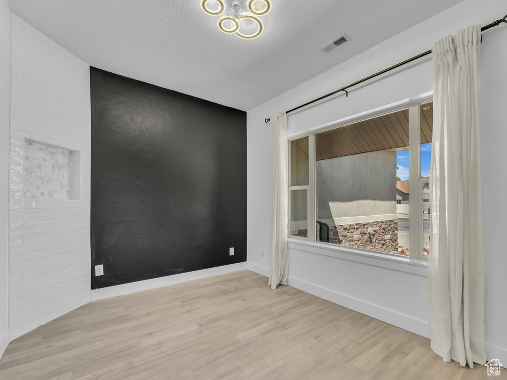 Spare room with wood finished floors and baseboards