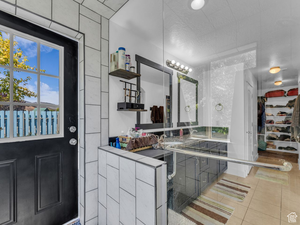 Bathroom featuring tile patterned floors and a textured ceiling