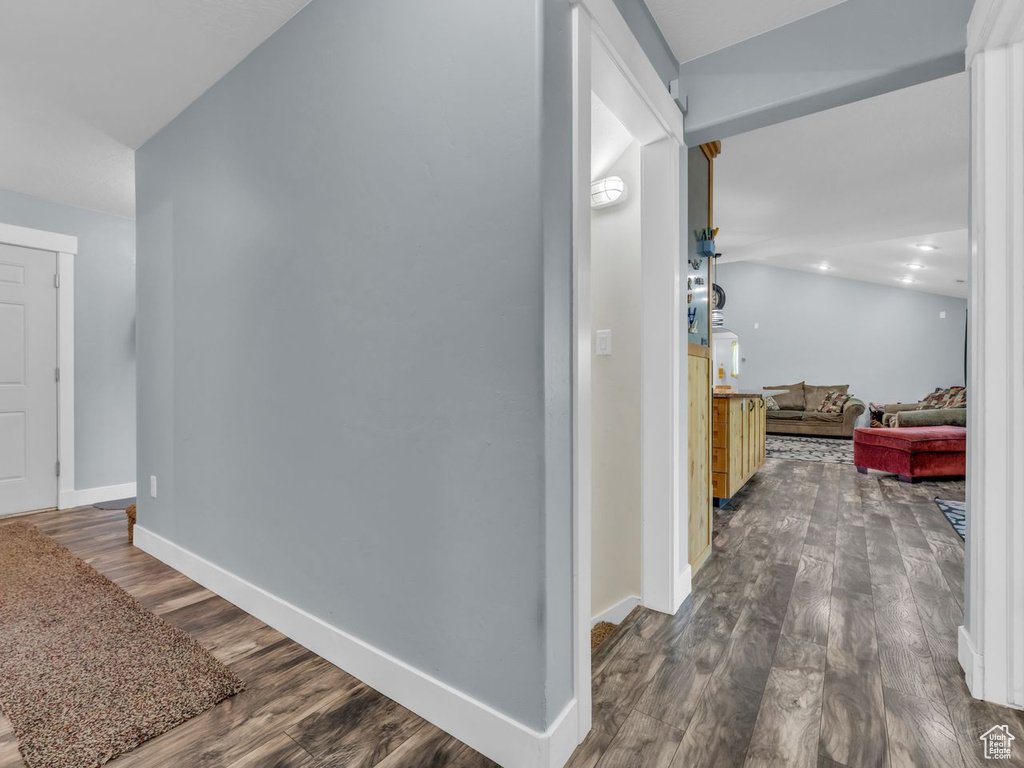 Corridor with dark wood finished floors and baseboards
