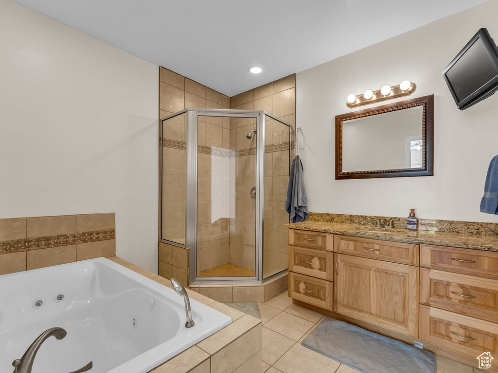 Bathroom featuring a shower stall, a whirlpool tub, vanity, tile patterned floors, and recessed lighting