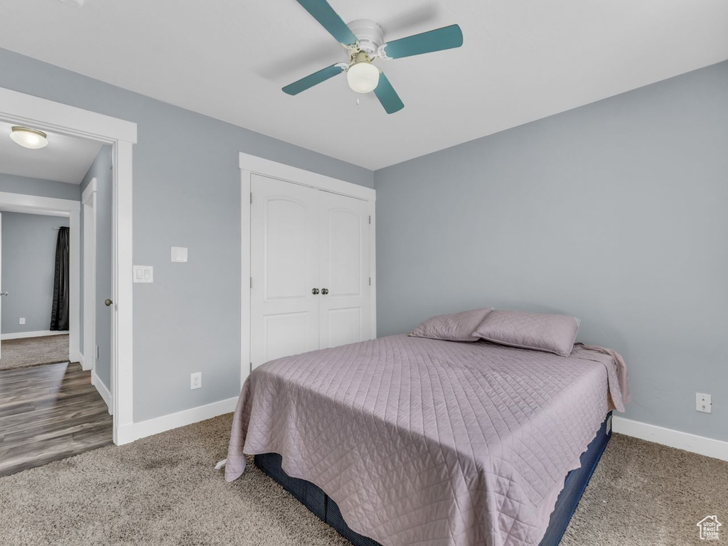 Bedroom with carpet flooring, a ceiling fan, and a closet