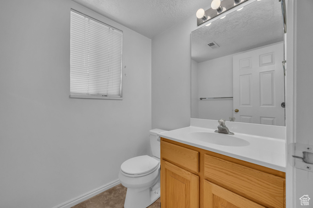 Bathroom featuring vanity and a textured ceiling