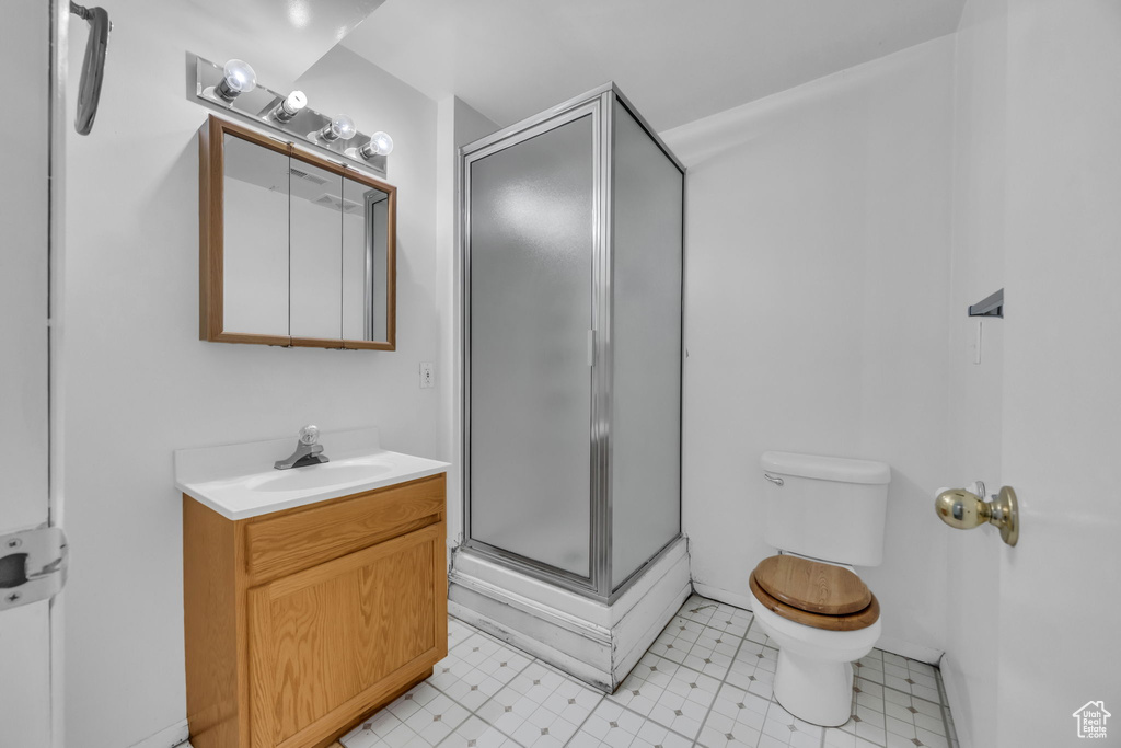 Bathroom with vanity and a shower stall