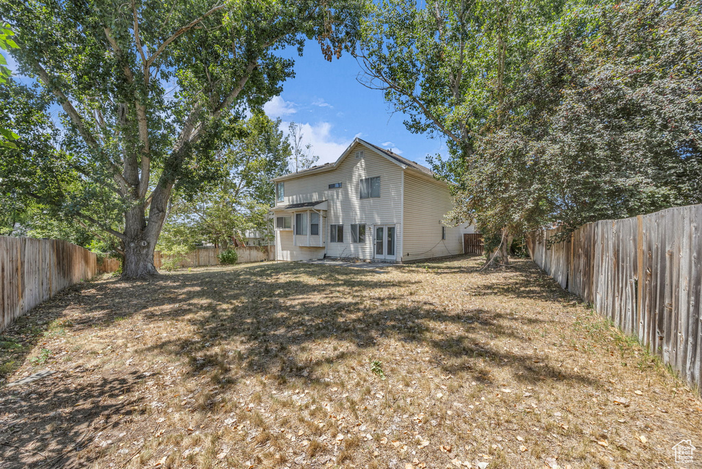 Back of property featuring a fenced backyard