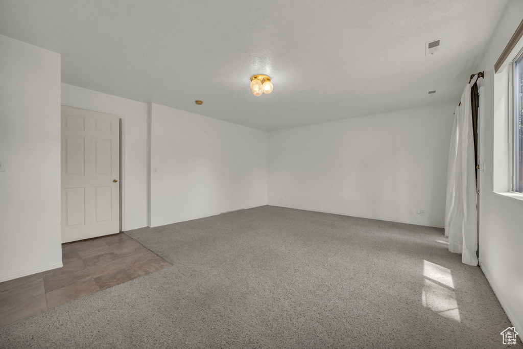 Unfurnished room featuring carpet flooring