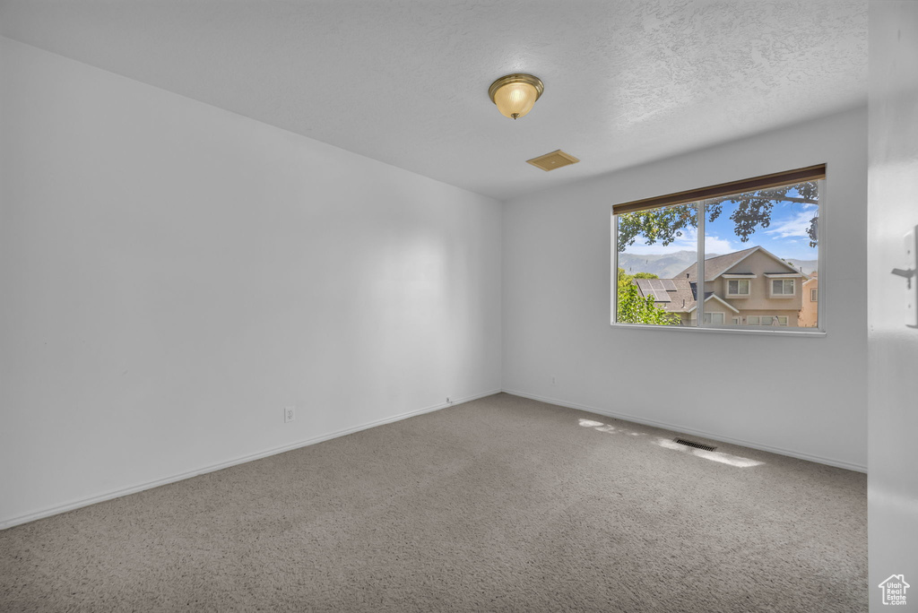 Empty room with baseboards and carpet flooring